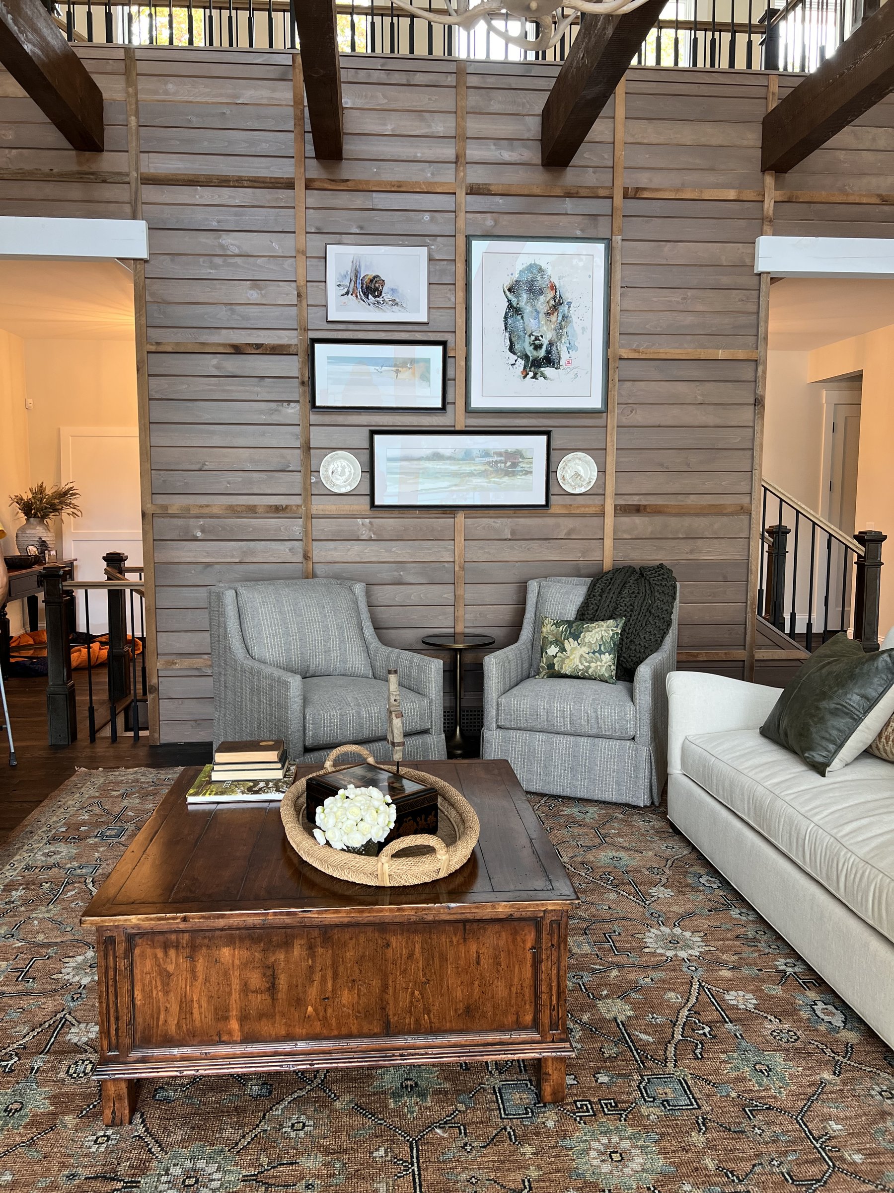 Soaring great room with gallery wall and exposed beams